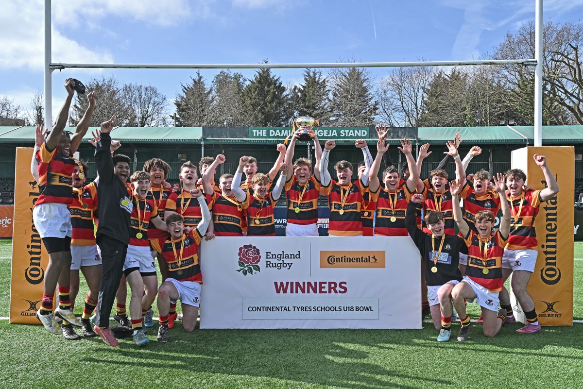 Hymers College cheering with their medals under the post