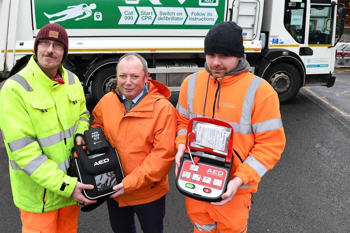 Launching the new defibrillator campaign in front of a bin lorry are Councillor Paul West, centre, with refuse crew members Andrew Fowler and Jay Hughes