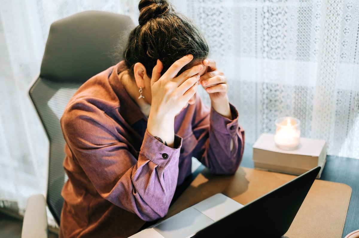 Woman feeling stressed working from home burnout