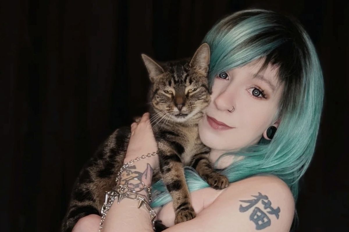 Cat Powling, one of the cafe co-founders, with her cat Weary Traveller,who has provided the naming inspiration for the cat cafe
