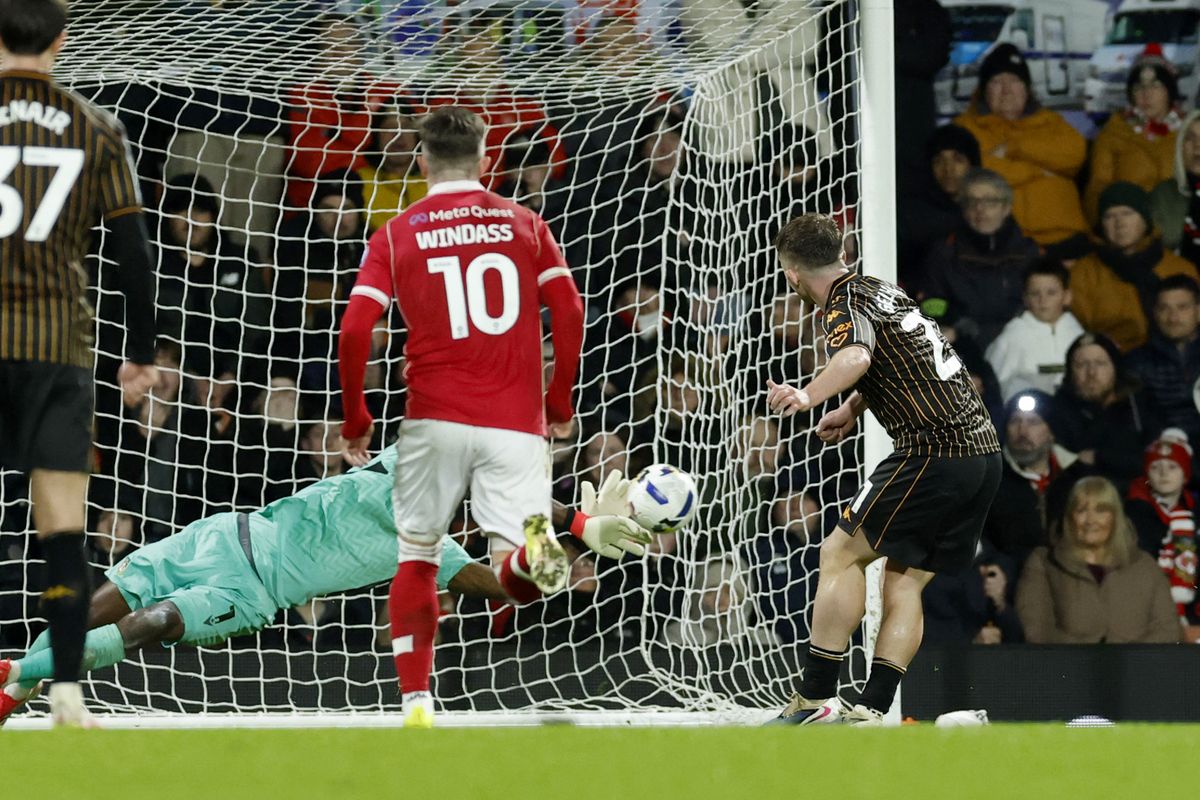 Wrexham goalkeeper Arthur Okonkwo saves Hull City's Joe Gelhardt's penalty kick