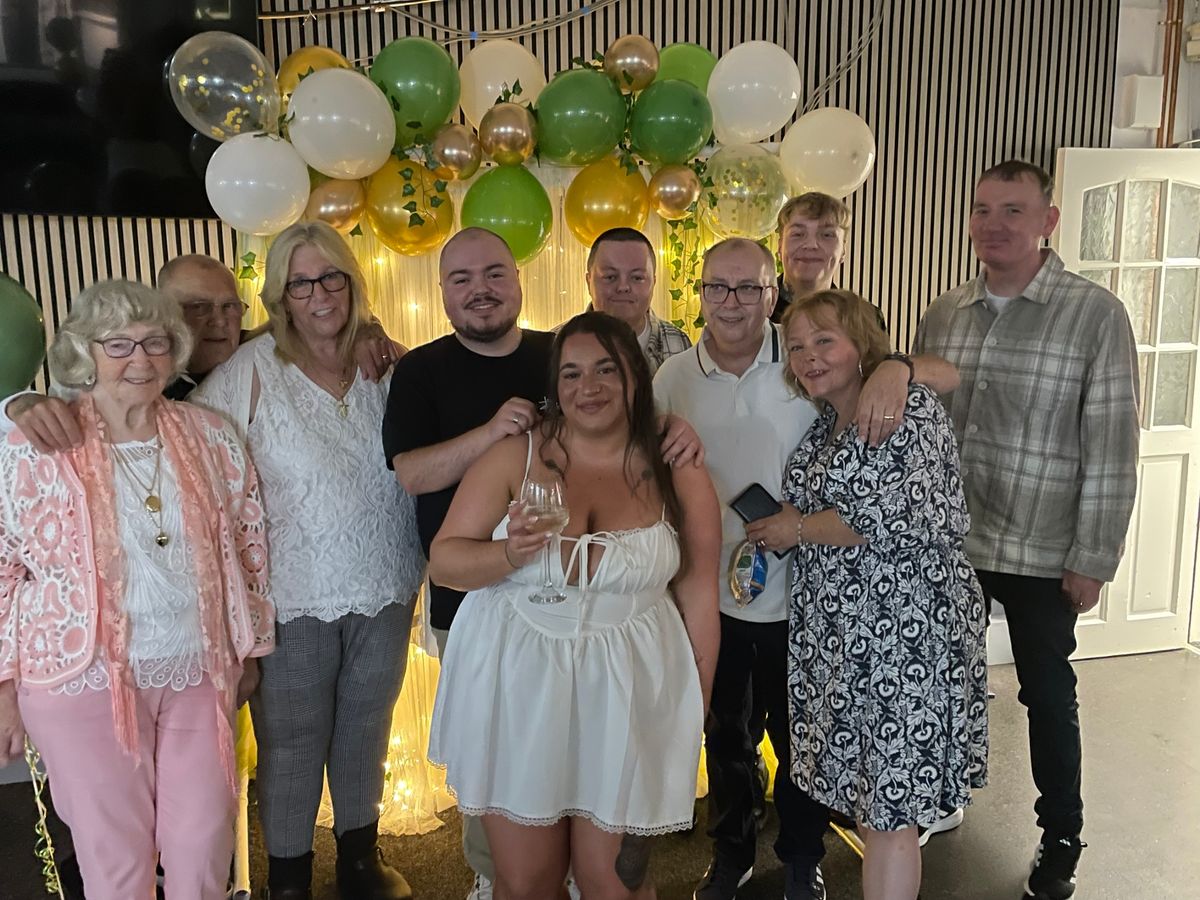 Nicola, second from right in black and white dress, surrounded by her family