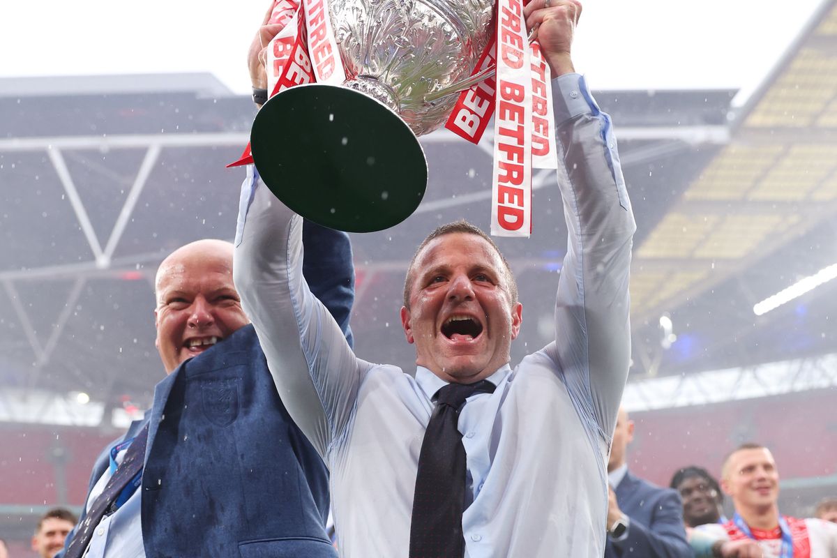 Hull Kingston Rovers' head coach Willie Peters lifts the trophy with CEO Paul Lakin.