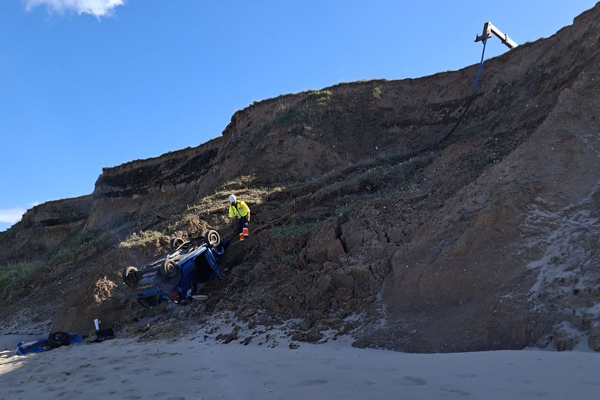 The abandoned car is lifted up the cliff at Waxholme, Withernsea.