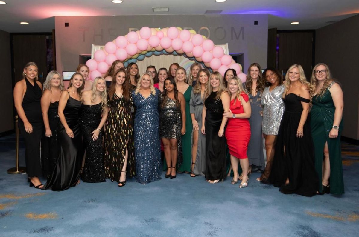 Sam, in the blue dress, at a Chasing Rainbows event