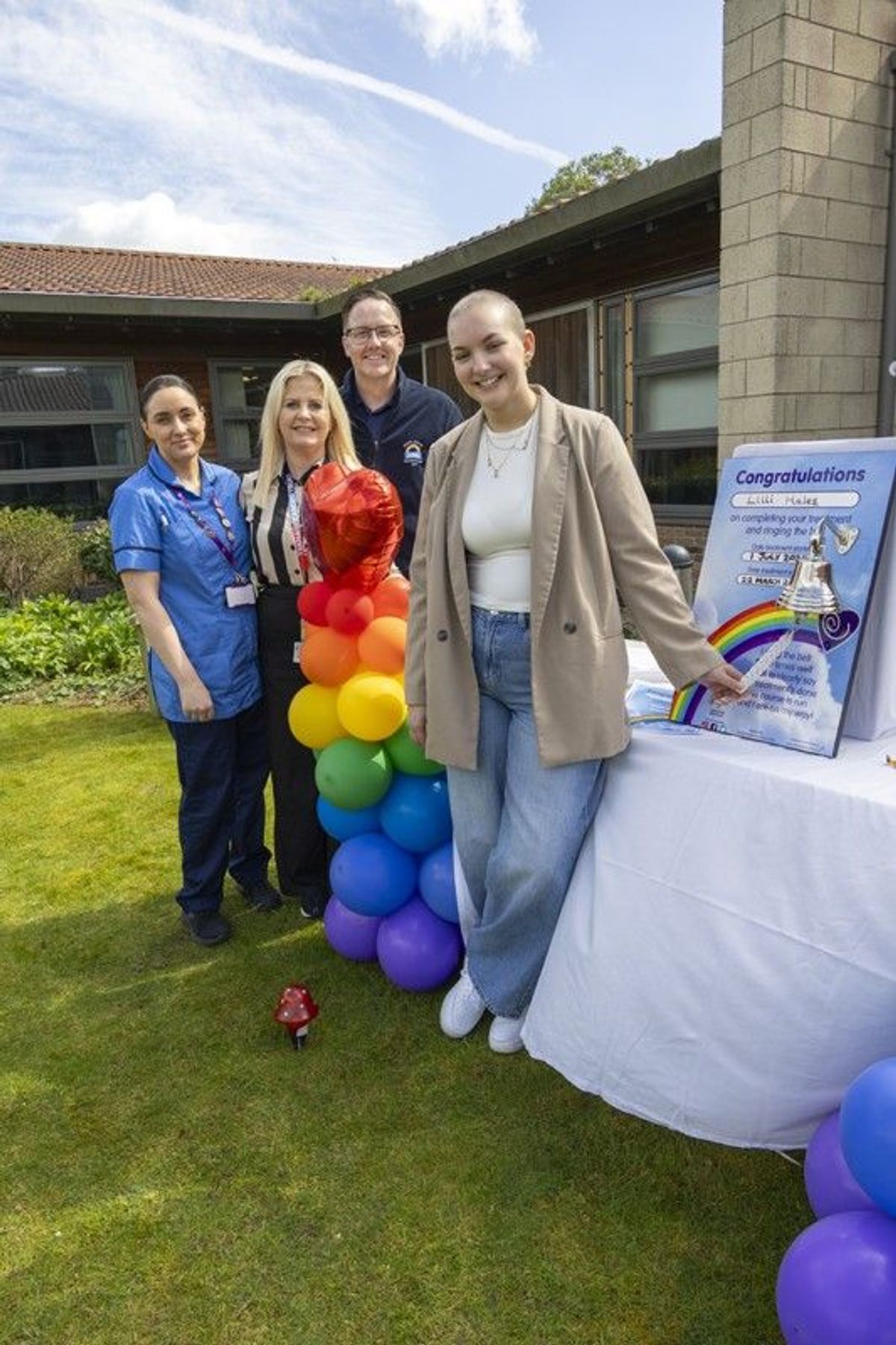 23/04/26 - Lilli Hales, who won the region’s hearts last summer when a rare cancer diagnosis prevented her from attending her graduation ceremony, has been given the ‘all clear’ and is now excited to be getting her life back. She returned to the Queen’s Centre for Oncology and Haematology in Cottingham to ring the ‘end of treatment bell’. Lilli outside Ward 33 with hospital staff (L-R) Kirsty, Charlene and Neil