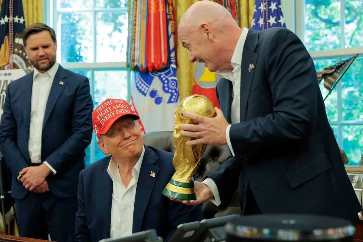 FIFA President Gianni Infantino shows President Donald Trump the World Cup Trophy in the Oval Office