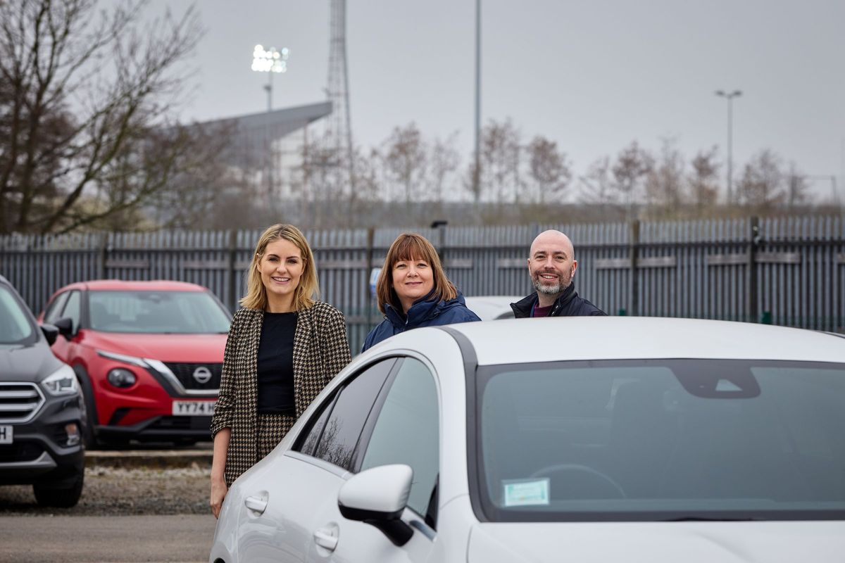 14/04/26 - Willerby’s manufacturing site is just a few minutes’ walk from the Sewell Group Craven Park stadium, so an idea was born to enable fans to use Willerby’s staff car park on busy matchdays. From left to right, HEY Children’s University’s Head of Development, Sarah Brodie, Willerby’s Head of Health, Safety and Environment Helen Capps and Dove House Hospice’s Partnership Development Fundraiser, Jonny Bottomley, are pictured in the car park which is being used on matchdays.