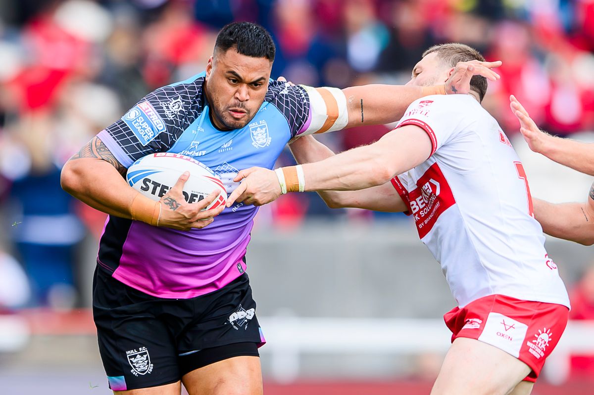 Hull FC's Sam Lisone fends off Hull KR's James Batchelor.