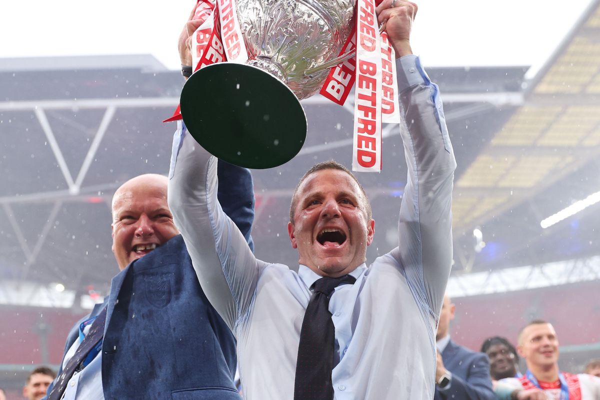 Hull KR head coach Willie Peters lifts the Challenge Cup trophy with CEO Paul Lakin at Wembley.