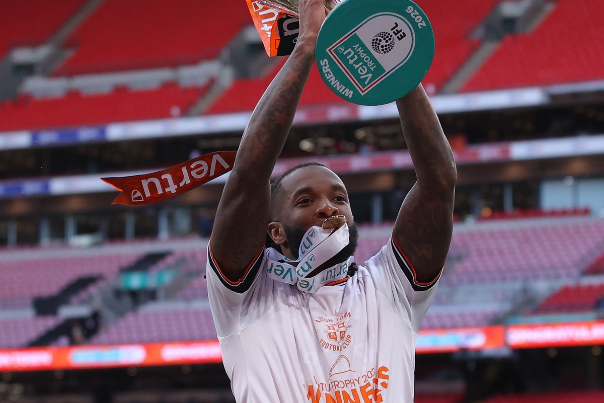 Kasey Palmer celebrates with the Vertu trophy at Wembley Stadium 