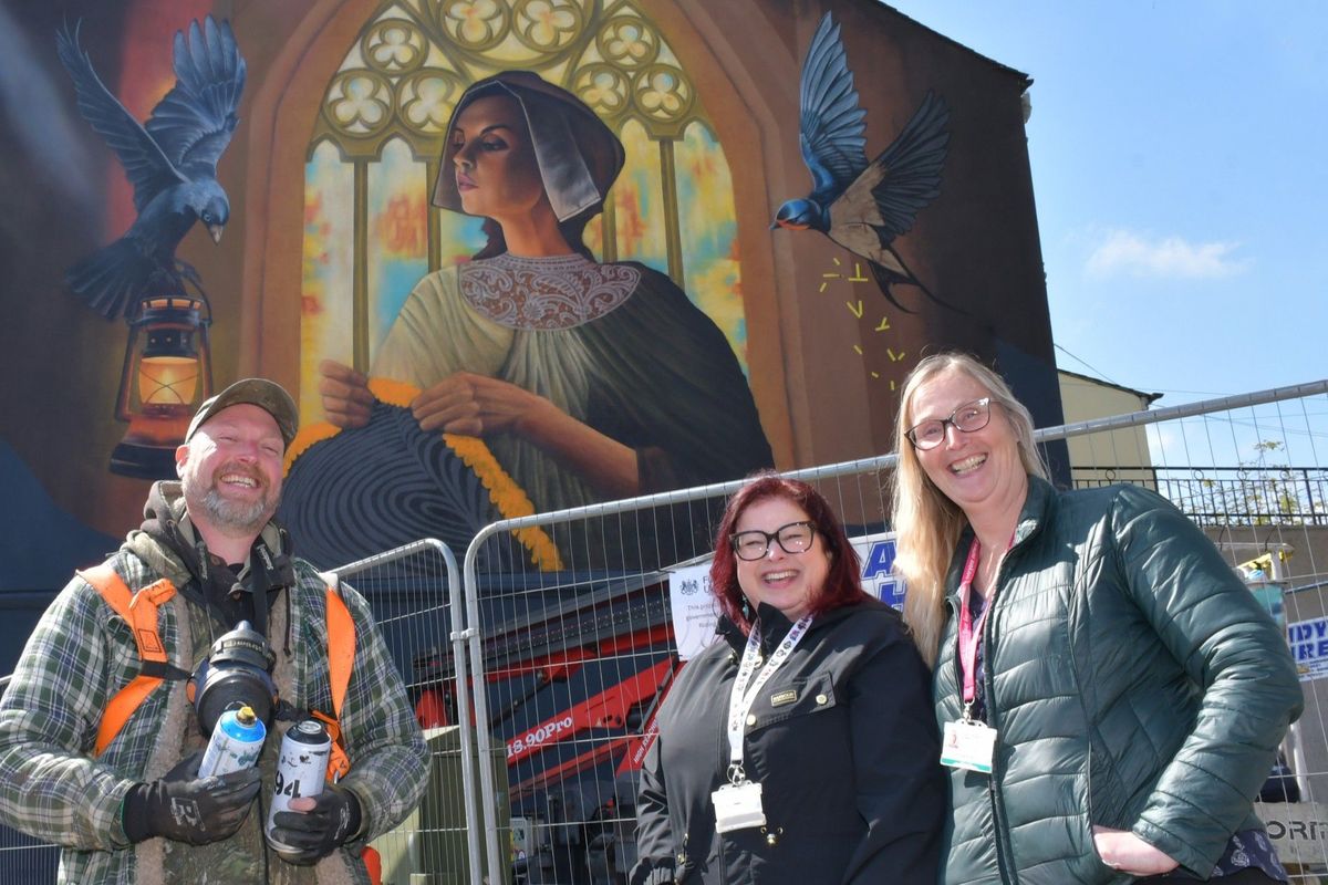 30/04/26 - Two colourful, eye-catching murals have been painted on the side of buildings in Bridlington as part of a £125,000 regeneration project. East Riding Council commissioned the huge murals, depicting aspects of the town’s history and local wildlife, as well as making improvements to the nearby Westgate Park in the Old Town and to Harbour Road to encourage more visits. In front of the striking Gansey Girl mural in Bridlington’s Old Town are, from left, artist Sam Porter, Angela Merrills (local growth coordinator at East Riding of Yorkshire Council), and Fiona Turner (project coordinator at the council).