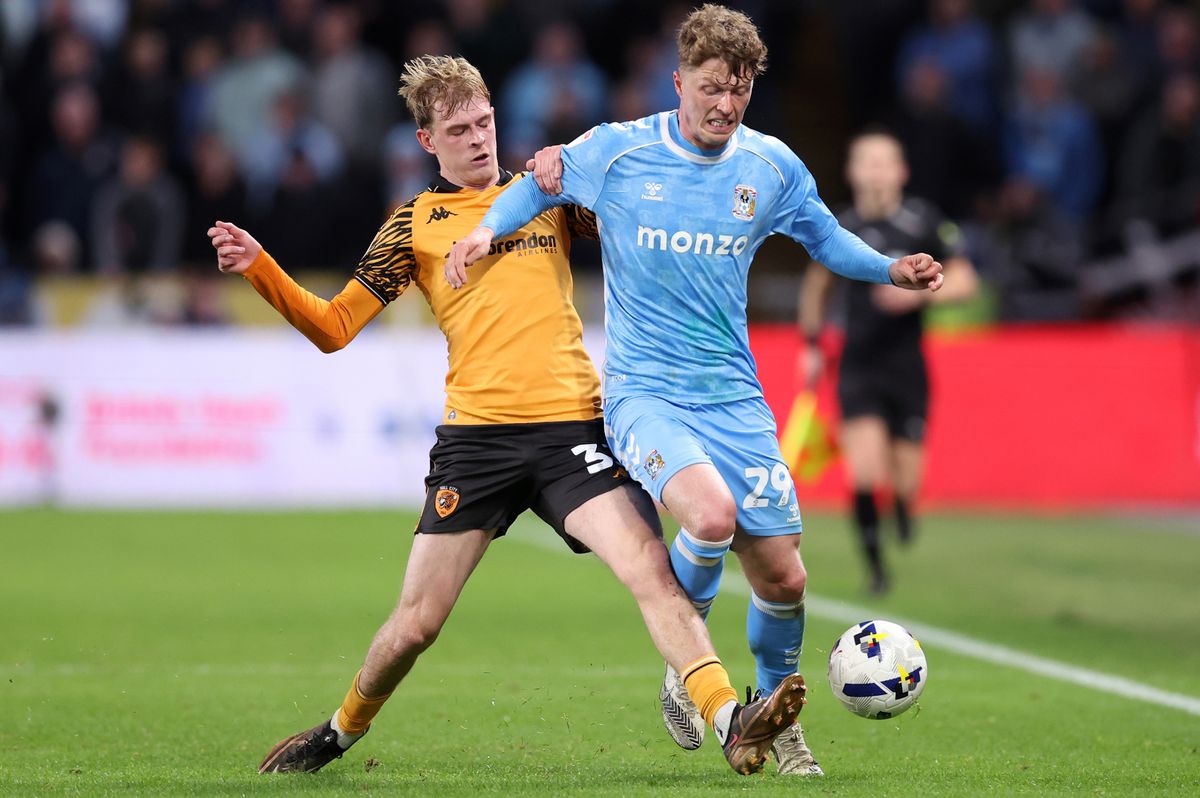 Victor Torp of Coventry City is challenged by Toby Collyer of Hull City