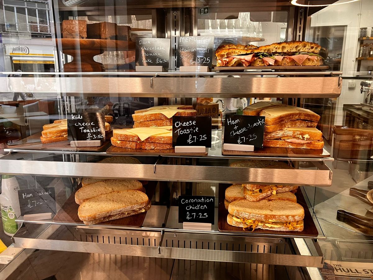 A selcetion of sandwiches and a dark chocolate mousse cake