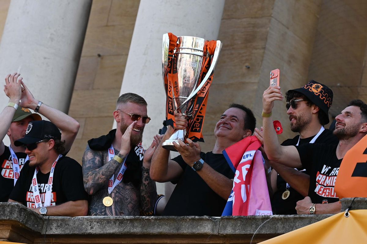 Hull City's players and Acun Ilicali celebrate promotion at City Hall