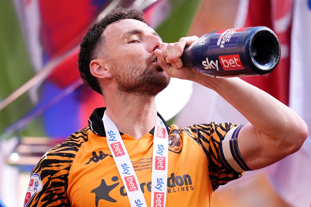 Hull City's Lewis Coyle celebrates with the trophy after winning promotion to the Premier League.