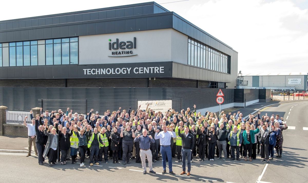 Ideal Heating employees celebrate The King’s Award with, front, from left, COO Jason Speedy, CFO Steve Hairsine, and training and design services director Andrew Johnson, outside the new UK Technology Centre at the company’s headquarters site in Hull.
