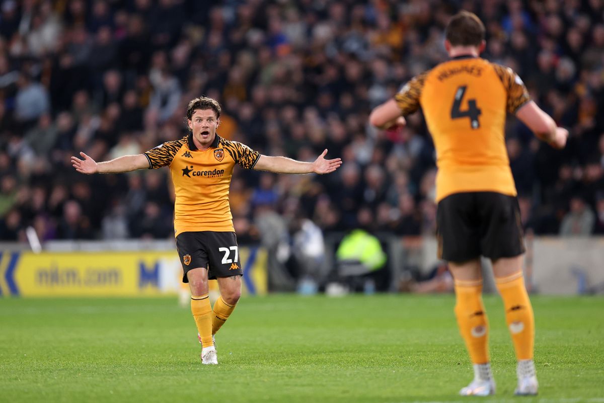 Regan Slater of Hull City reacts towards teammate Charlie Hughes 