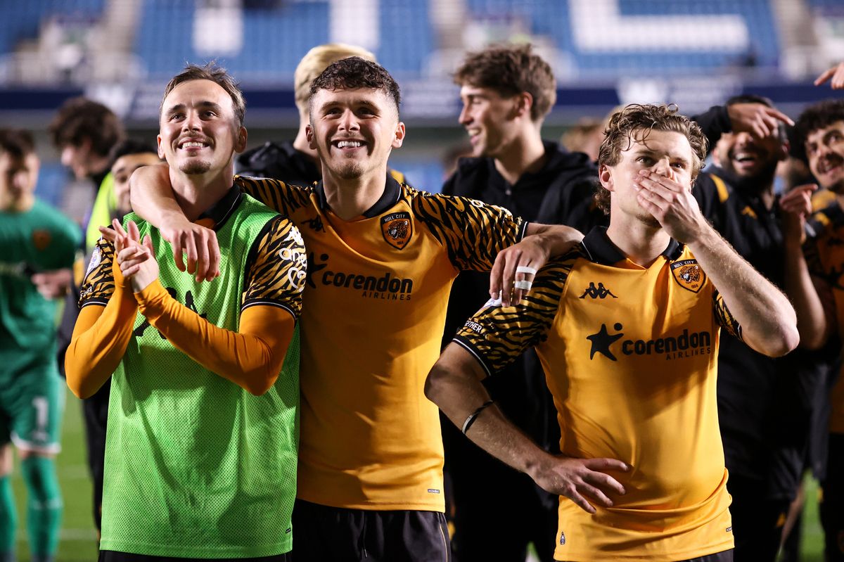 Liam Millar, Ryan Giles and Regan Slater of Hull City stand to take in the moment while celebrating during the Sky Bet Championship Play Off Semi Final Second Leg match between Millwall and Hull City