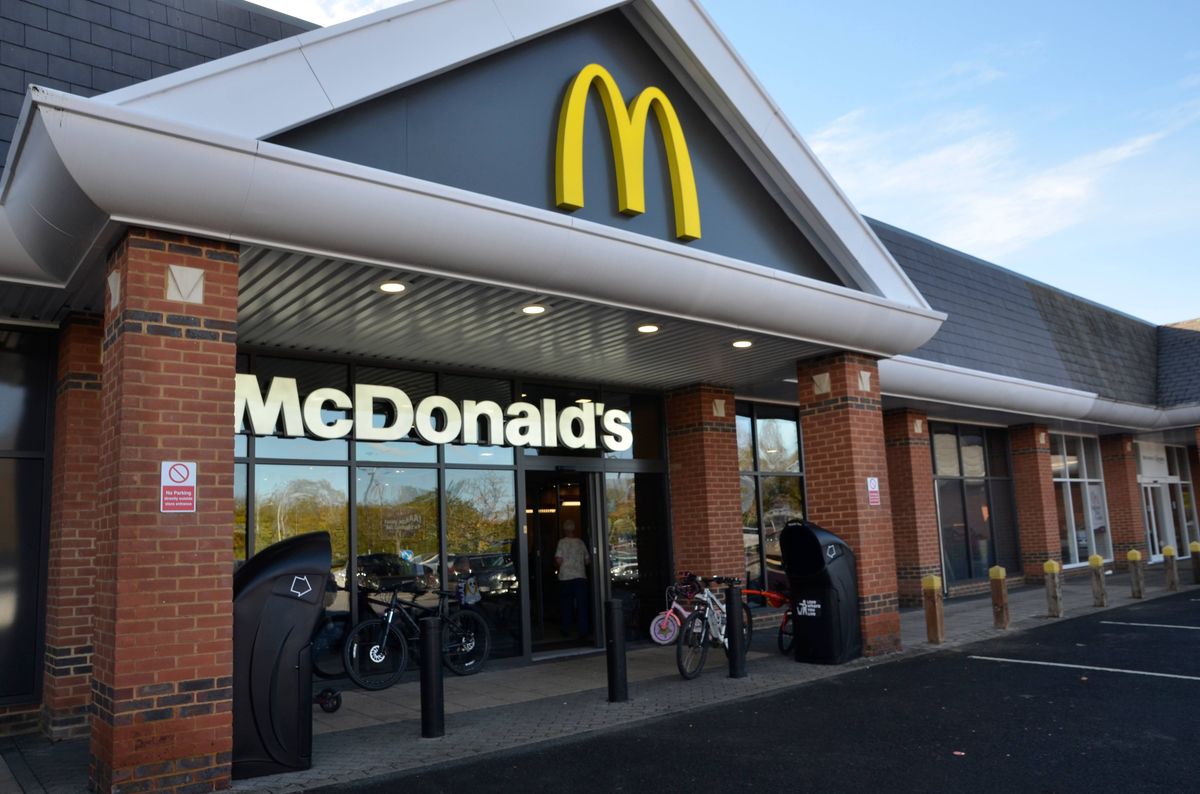 Basingstoke, UK - October 27, 2024: Exterior of the McDonald's restaurant at a row of retailers in Hatch Warren, Basingstoke, Hampshire on a sunny autumn day.