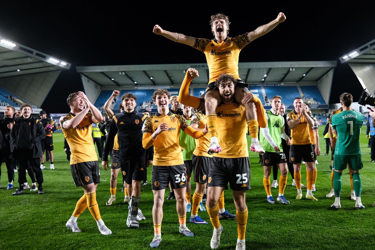 Regan Slater celebrates victory on the shoulders of Matt Crooks at The Den