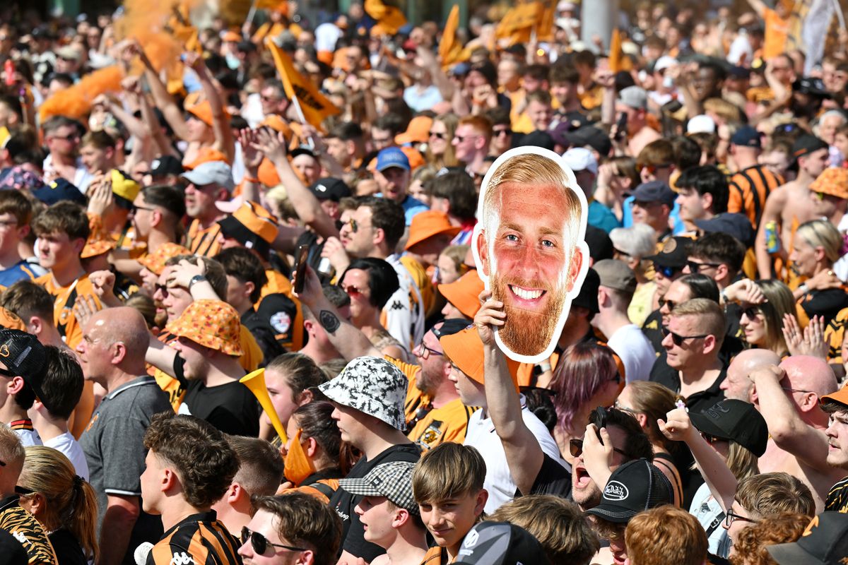 Hull City fans holding up a cardboard cut out of Oliver McBurnie during a victory parade