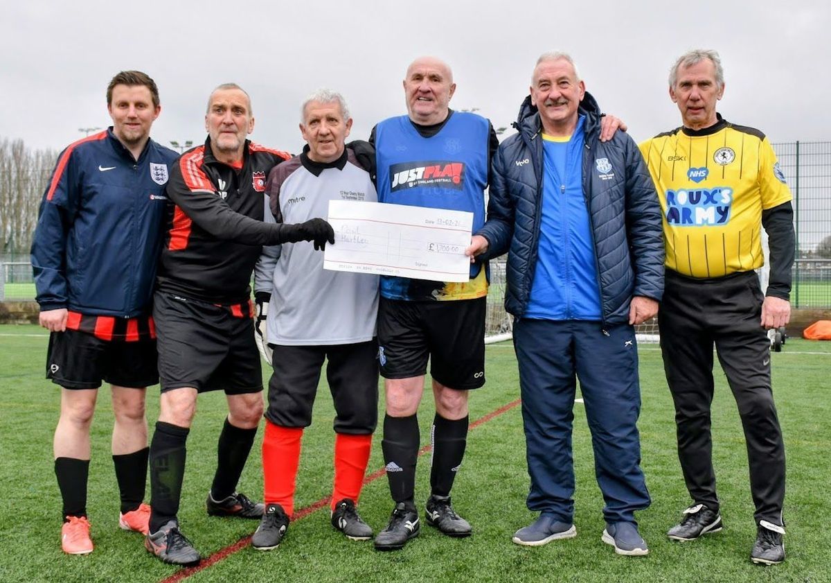Glen Hartley, far left, and his dad Paul Hartley, third left, at the cheque presentation at the walking football tournament hosted by Cottingham Rangers WF earlier this year