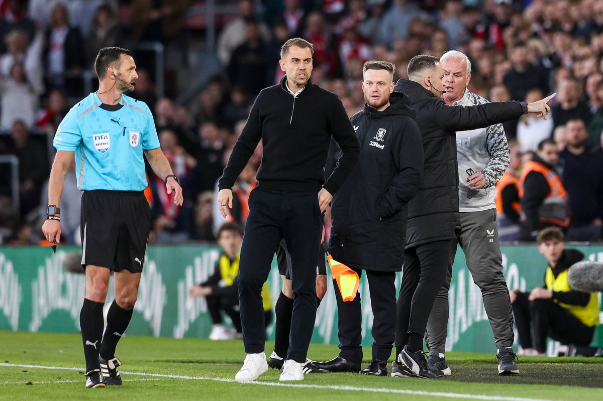 Referee Andy Madley has words with Kim Hellberg of Middlesbrough and Tonda Eckert of Southampton as tempers simmer during the semi-final