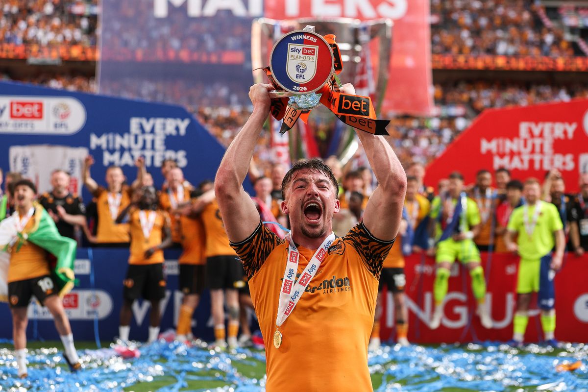 Charlie Hughes of Hull City celebrates with the trophy