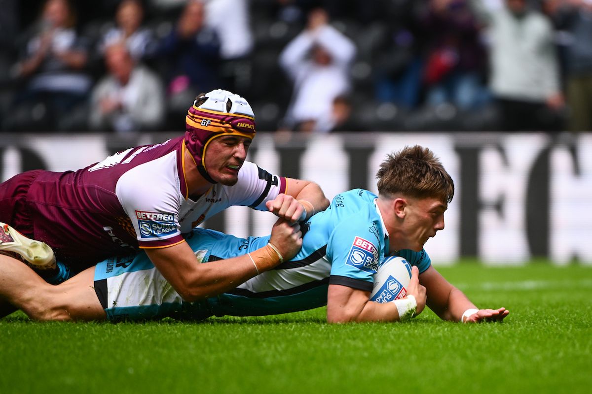 George Flanagan of Huddersfield fails to stop Logan Moy of Hull FC from scoring a try