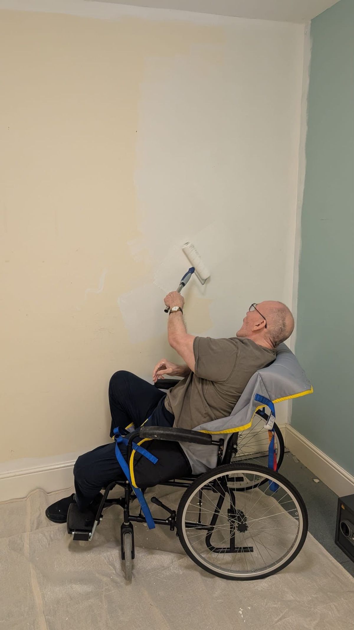 Bob McKenna painting a room in Alexandra Court