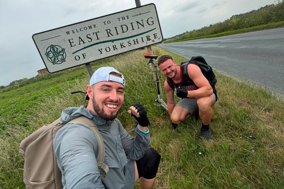 Joel Redhead and Shane Cole reach the East Riding of Yorkshire boundary on their scooters