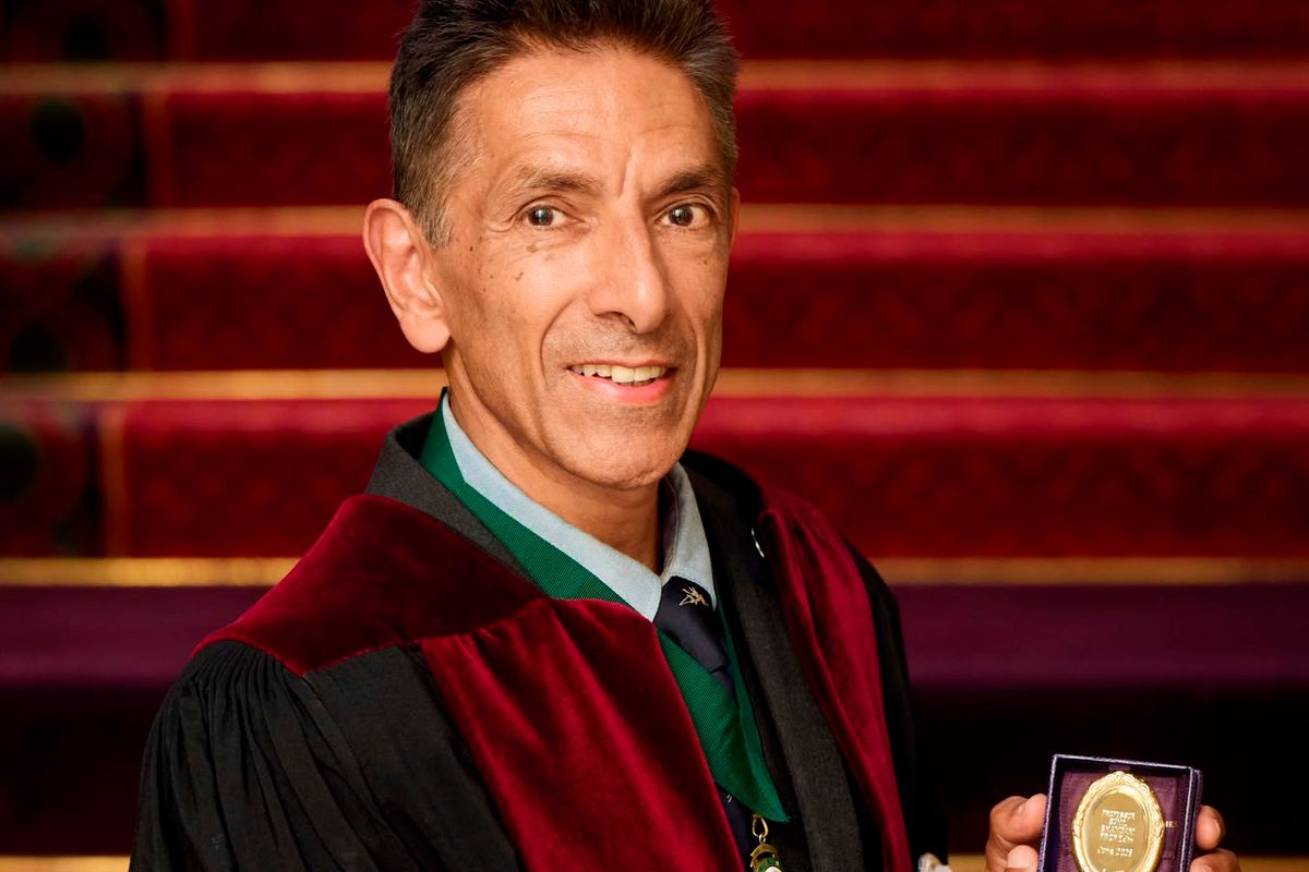 Professor Bhandari holding the medal.