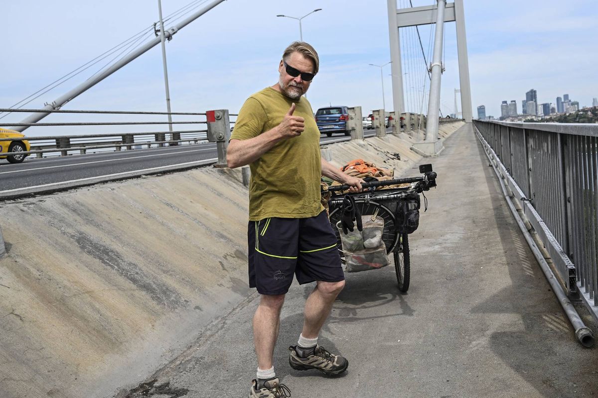 ISTANBUL, TURKIYE - MAY 2: British traveler Karl Bushby crosses the 15 July Martyrs Bridge from Asia to Europe with special permission in Istanbul, Turkiye on May 2, 2025. Bushby sets out from Chile 26 years ago to reach his home and came to Istanbul to prove that the journey between continents can be made only on foot. (Photo by Murat Sengul/Anadolu via Getty Images)