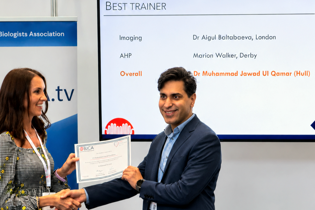 Dr Jawad Ul Qamar shakes an unknown woman's hand as he receives a certificate