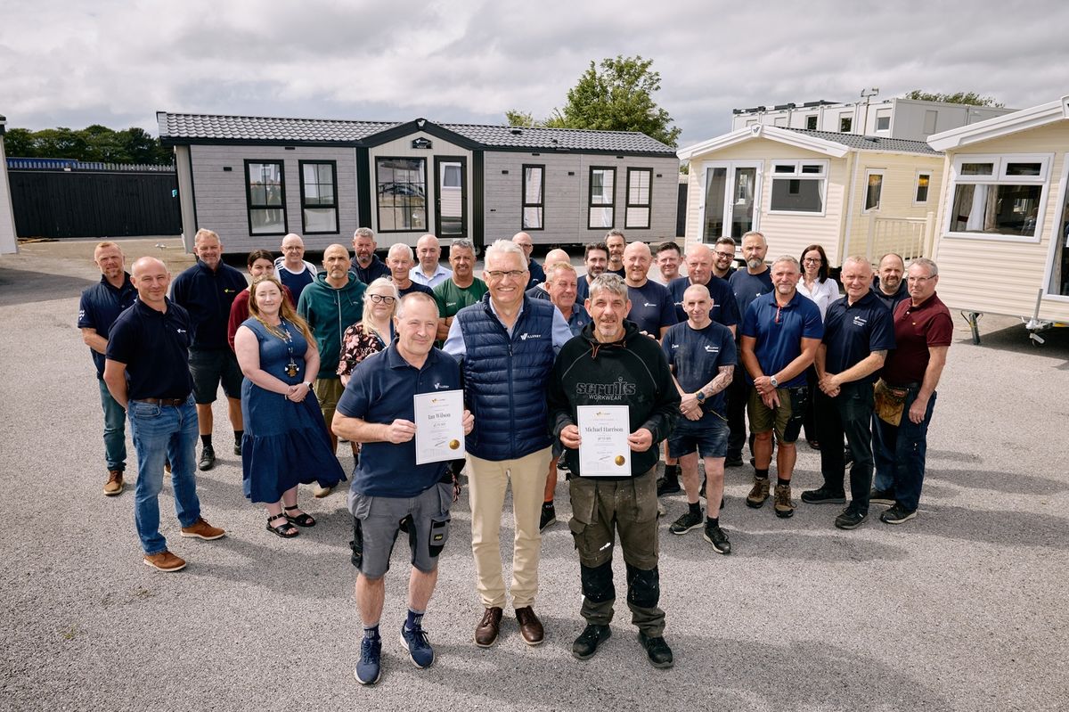 Willerby CEO Peter Munk with Ian Wilson, left, and Michael Harrison, who have both recorded more than 40 years with the business, with fellow long servers behind.