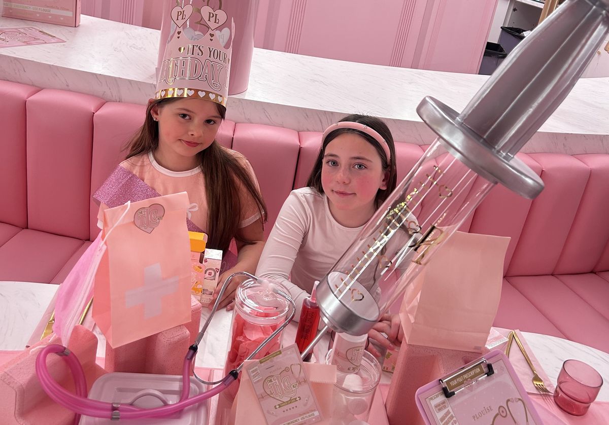 Sienna Sutton and Grace Hubbard smile for the camera at a birthday party