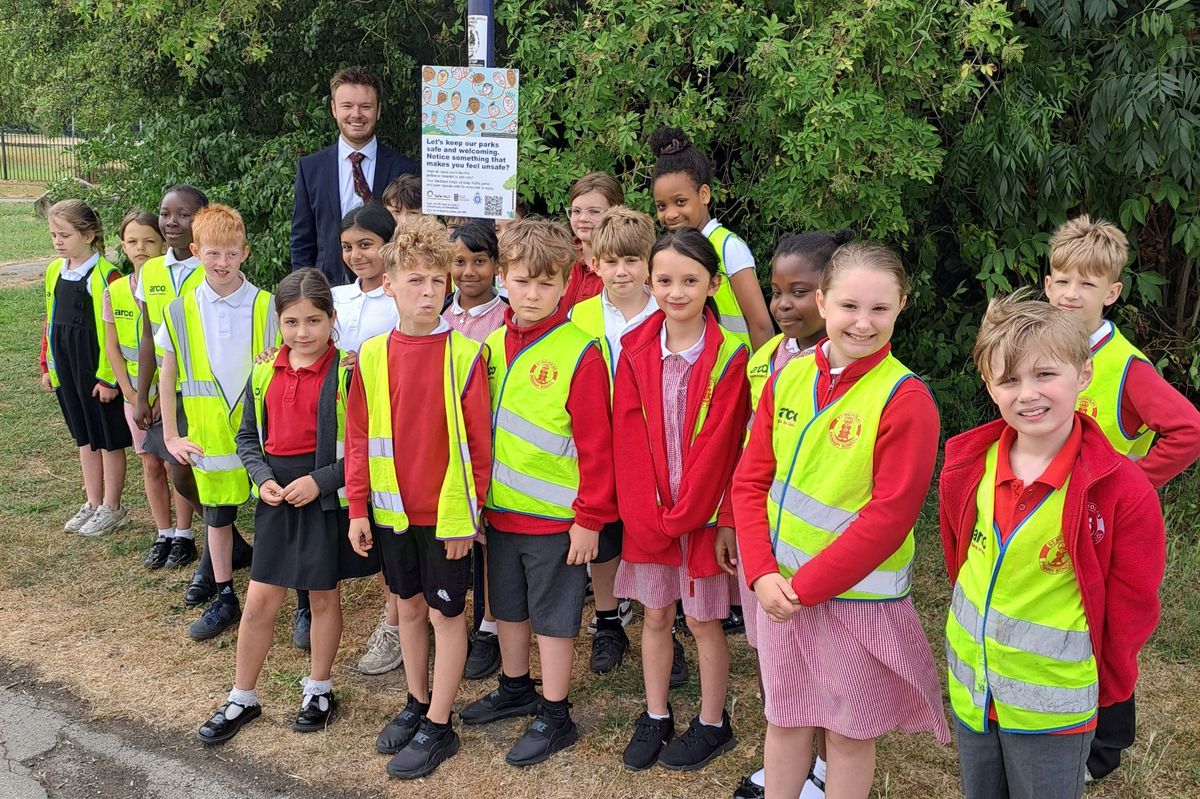 Children from St Nicholas Primary School in Hull at Oak Road Playing Fields with the safety sign they helped create, joined by Cllr Ted Dolman