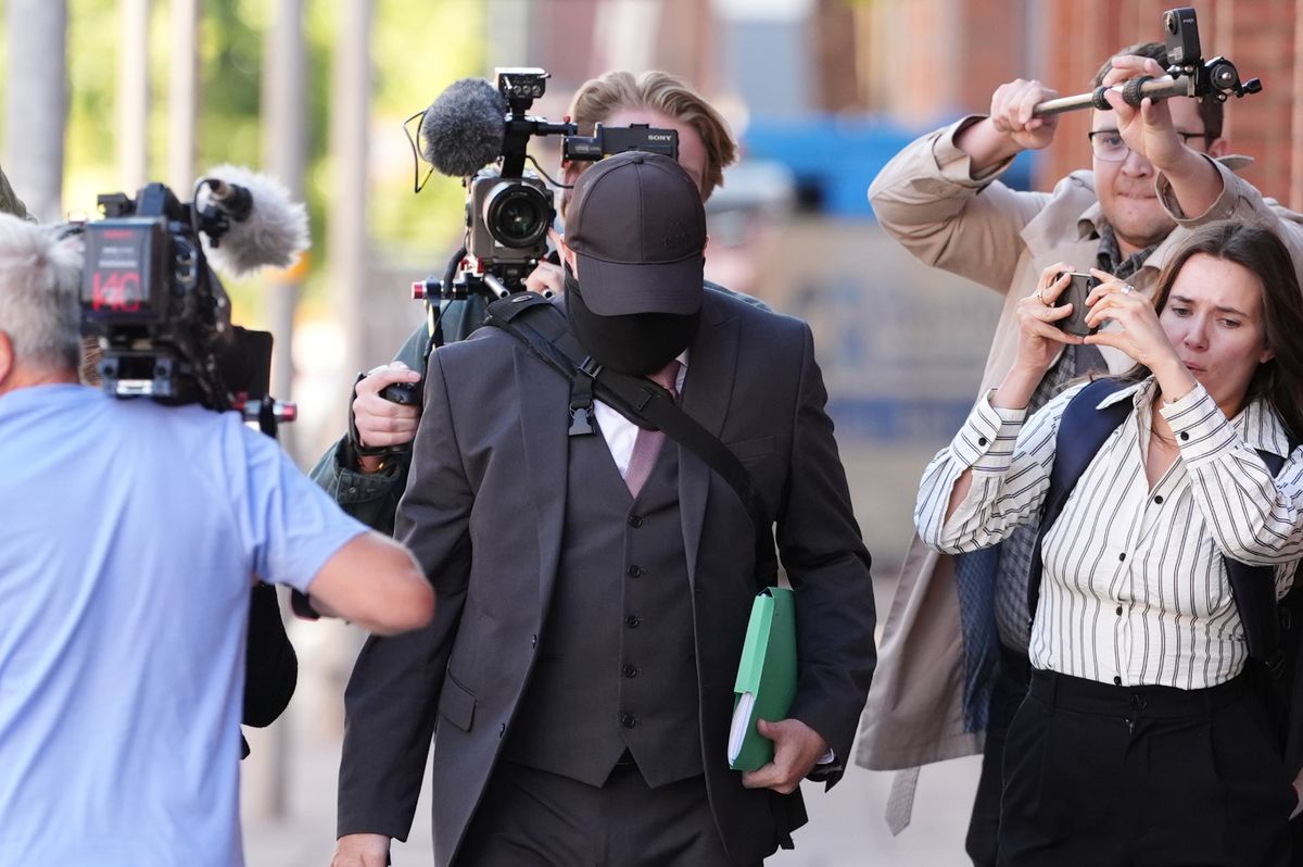 Funeral director Robert Bush (centre) arrives at Hull Crown Court