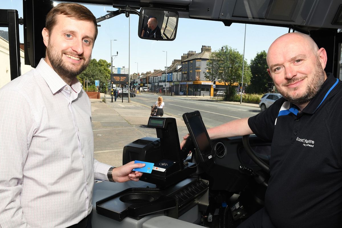 Councillor Nick Coultish and Stuart Fillingham show the new Tap On, Tap Off technology installed on East Yorkshire Buses. 