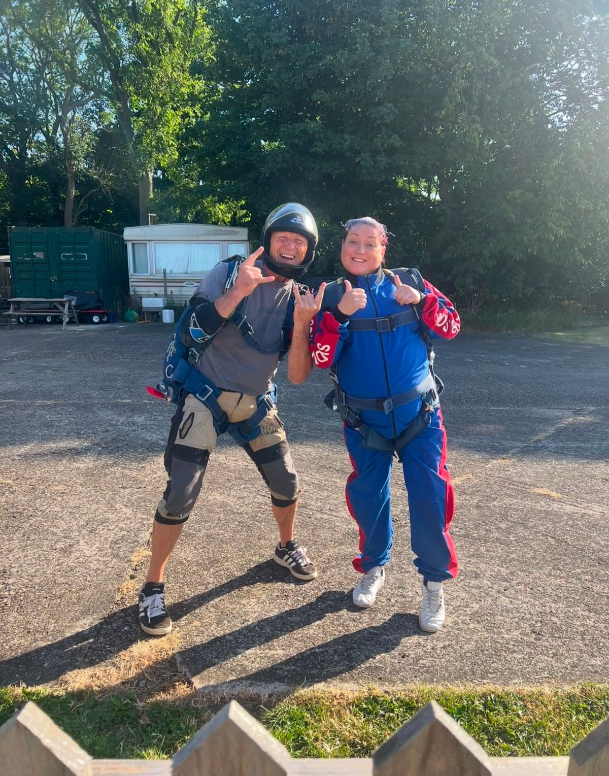 Paula in her sky dive suit gives a thumbs up to the camera