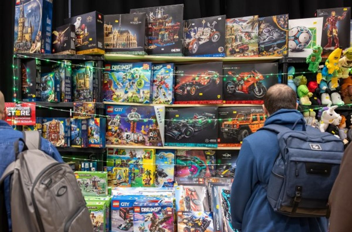 LEGO fans browse a wall of LEGO available to buy