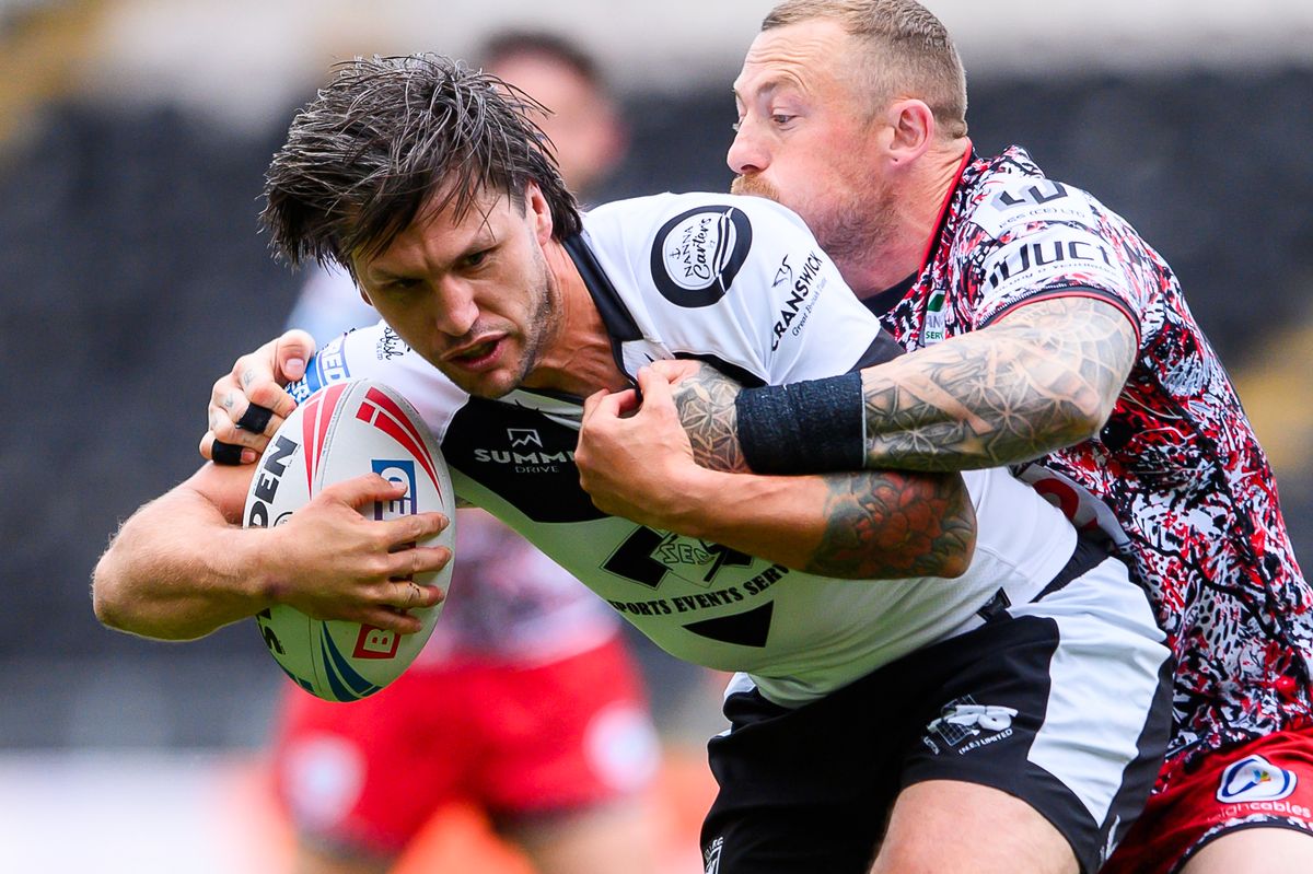 Hull FC's Tom Briscoe is tackled by Leigh's Josh Charnley.