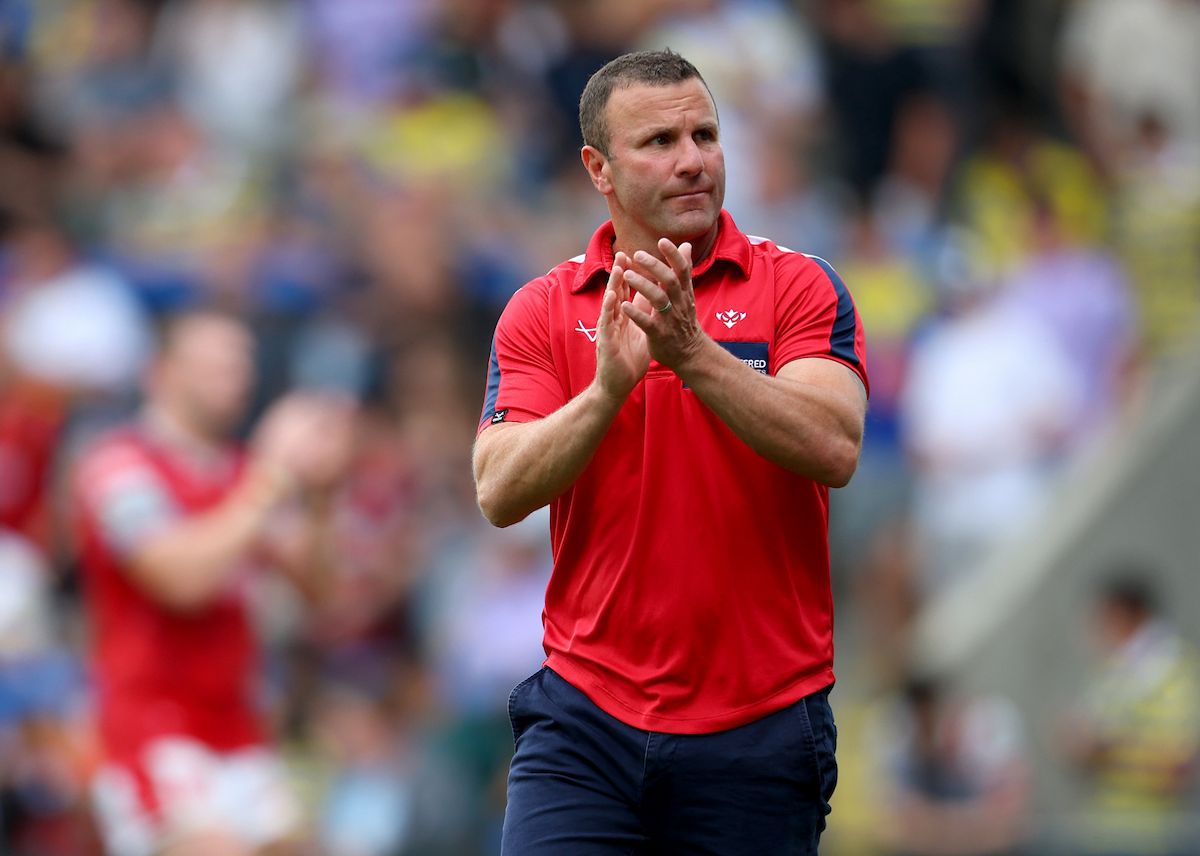 Hull KR head coach Willie Peters applauds the fans after the match at Warrington