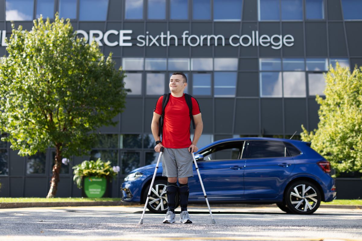 Ben Shepherd outside his new workplace with his adapted car