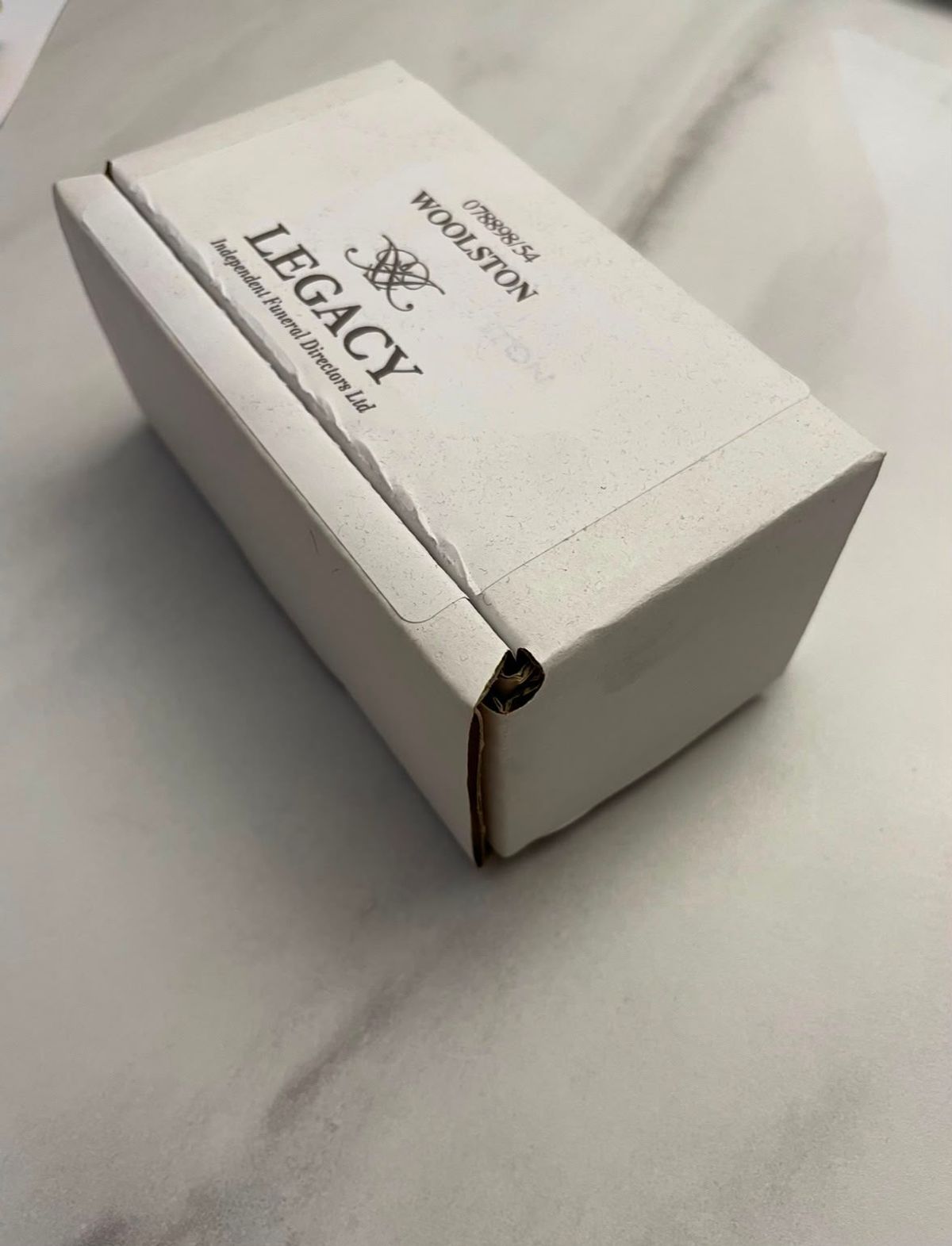 The box containing ashes that was given to Katie and Tom in 2023