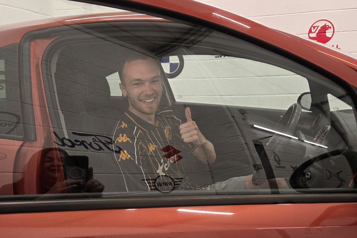 Hull City fan Sam Spencer prepares to drive away in the Vauxhall Corsa he won from 1st Car