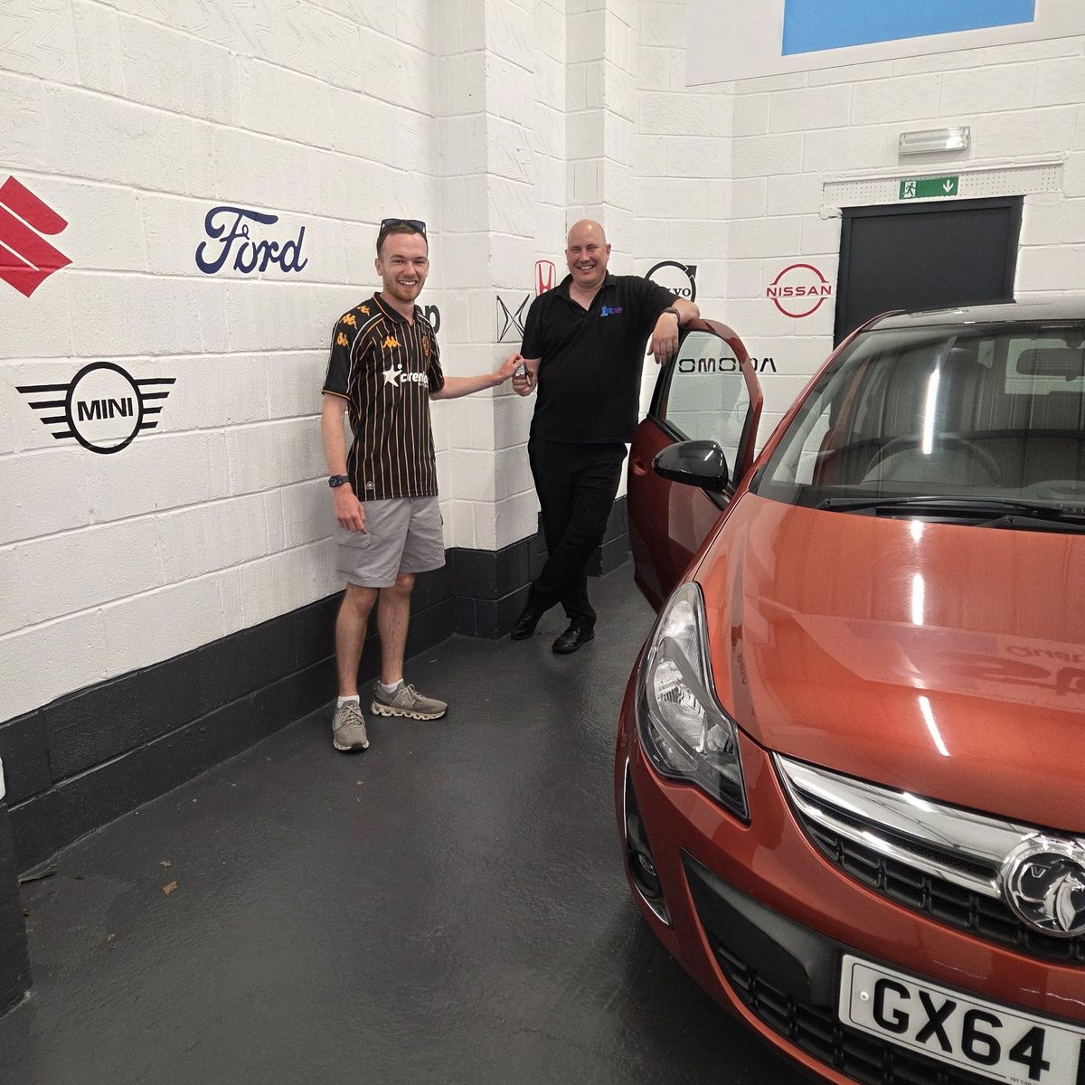 Sam Spencer, left, with David Hicks, sales executive at 1st Car, and the prize Vauxhall Corsa