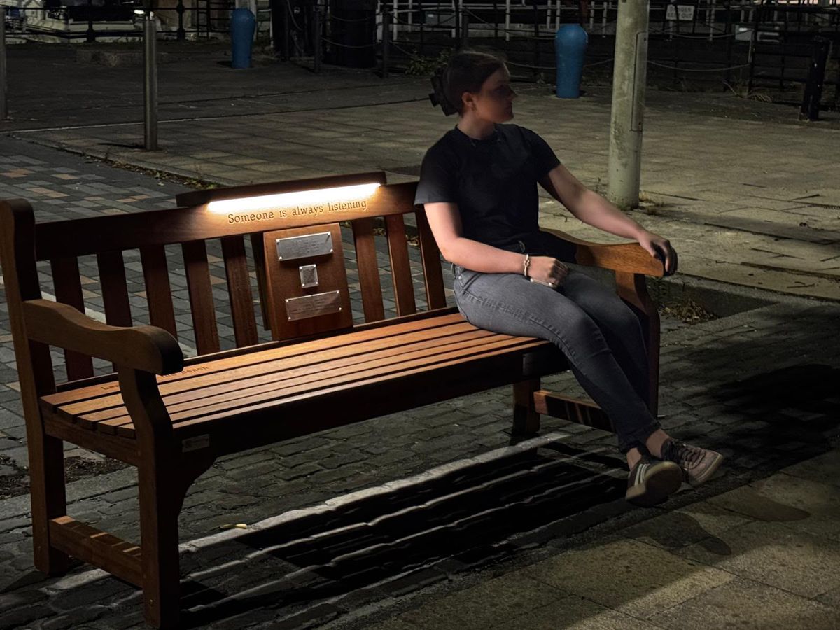 Mary Hallett sits on the Suicide Prevention Bench she raised funds for in memory of her mum