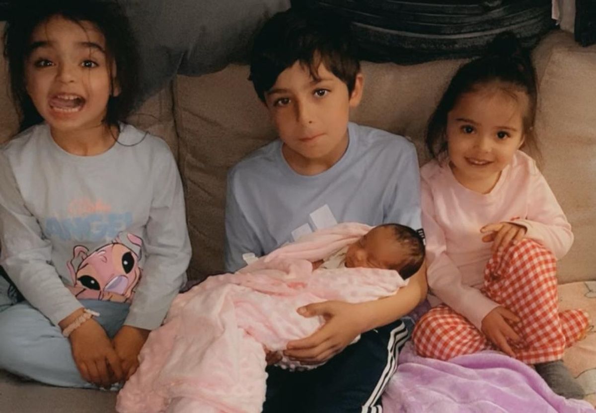 Charlie Norman's children Amna, 5, Leeroy, 10, Amyra 1 and Amina, 3 sit on the sofa when Amyra was a newborn